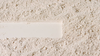 Beige Powder Surface with Dragged Trace and Shifting Shadows