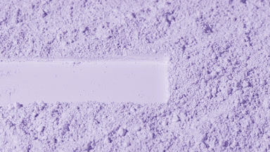 Violet Powder Surface with Dragged Imprint and Shifting Shadows