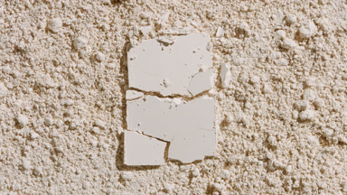 Cracked Rectangular Powder on Beige Surface