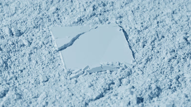 Cracked Powder on Pale Blue Surface with Vivid Shadows