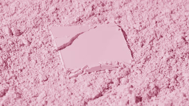 Cracked Powder on Light Pink Surface with Changing Shadows