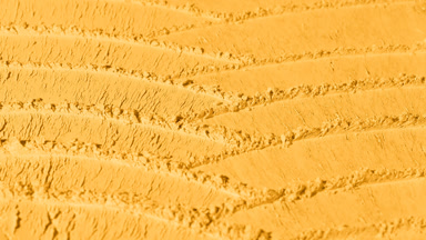 Yellow Powder Surface with Evolving Shadows from Knife Strokes