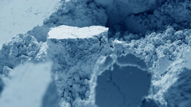 Slow Motion Close-Up of Disturbed Pale Blue Powder