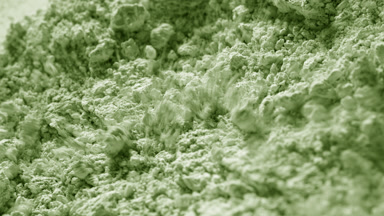 Pale Green Powder Surface Disturbed by Airflow in Close-Up