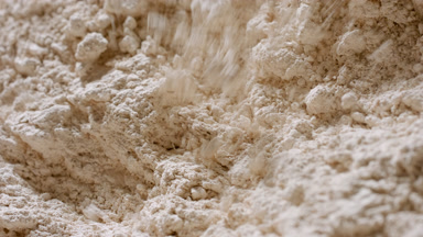 Beige Powder Surface Affected by Airflow in Extreme Close-Up