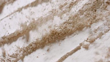 Beige Loose Powder Particles Blown Away in Slow Motion