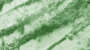 Pale Green Powder Particles Blown Away in Macro Slow Motion