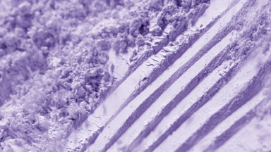Slow Motion Close-Up of Violet Loose Powder Displacement