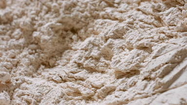 Extreme Macro Shot of Beige Powder Surface in Motion