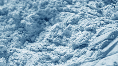 Slow Motion Close-Up of Pale Blue Powder Surface