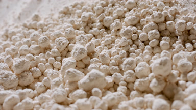 Close-Up of Light Beige Powder Balls Rolling Down Slope
