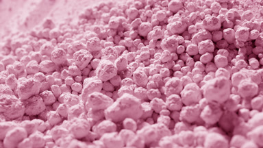 Light Pink Powder Balls Rolling Down Slope in Macro