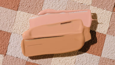 Close-Up of Foundation Cream on Brown Mosaic Surface