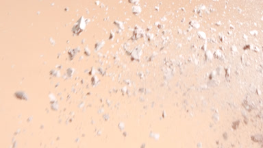 Macro Slow Motion of Beige Powders Colliding