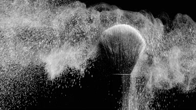 Slow-Motion Black Brush Flicking White Powder on Canvas