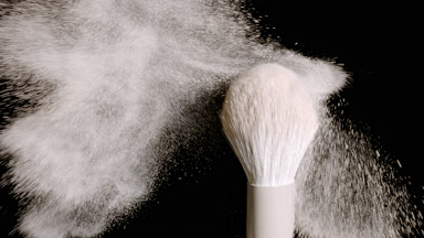 Extreme Close-Up of White Brush with Beige Powder