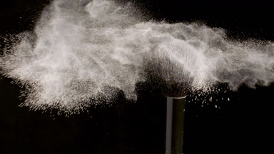 High-Magnification Shot of Black Brush with Beige Powder