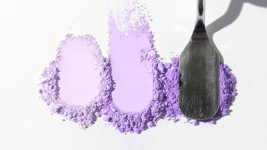 Three Violet Powder Heaps on Gentle Gray Backdrop