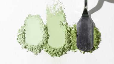 Close-Up of Pale Green Powder Heaps on Gray Canvas