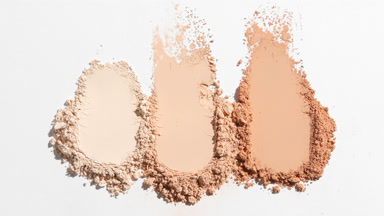 Beige Powder Smears on Soft Gray Backdrop with Shadows