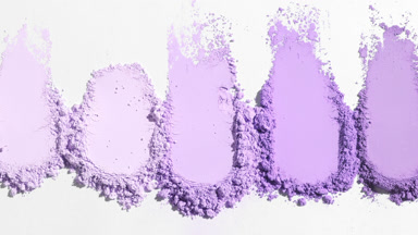 Violet Loose Powder Streaks on Soft Gray Backdrop