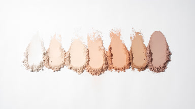 Beige Loose Powder Streaks on Light Grey Background