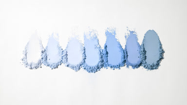 Blue Loose Powder Streaks on Light Gray Backdrop