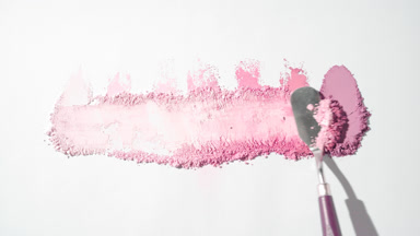 Pink Powder Smears on Light Grey Surface