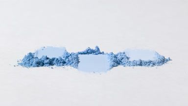 Tight Close-Up of Blue Powder Smears on Light Grey