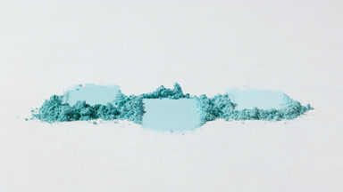 High-Magnification Close-Up of Cyan Powder Smudges