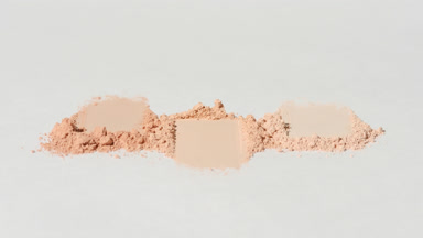 Macro Close-Up of Beige Powder Smudges on Light Grey
