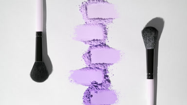 Violet Smeared Powder Heaps on Light Grey Background