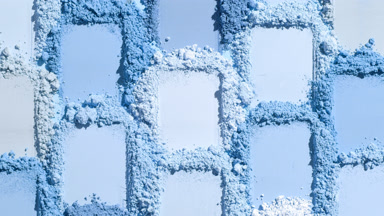 Intimate Close-Up of Blue Powder Heaps with Moving Shadows