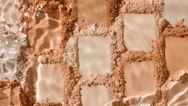 Close-Up Water Stream on Beige to Brown Powder Mosaic