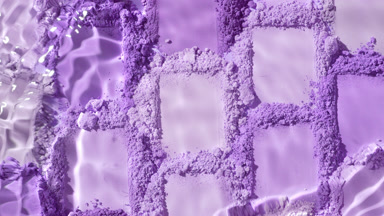 Close-Up Water Stream on Violet Powder Smears