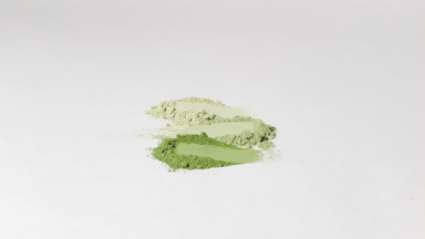 Vertical Arc Shot of Aligned Green Powder Streaks