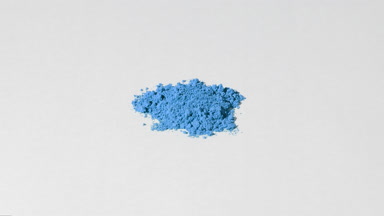 Blue Powder Extreme Close-Up on Light Grey Background