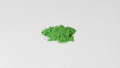 Green Powder Detailed Close-Up on Light Grey Backdrop