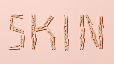 Wooden Clothespins Spell 'Skin' in Dynamic Motion