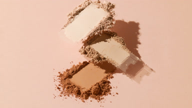 Dimensional Skin Tone Powder Heaps on Beige Background