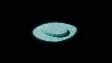 Close-Up of Cyan Powder and Puff with Sharp Shadows