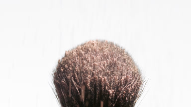 Beige Powder Falling on Black Brush for Ad