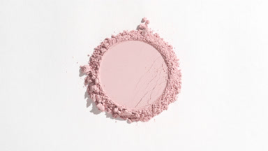 Pastel Pink Powder with Round Imprint on Grey Background