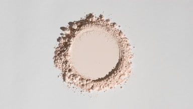 Above Shot of Beige Powder with Round Imprint