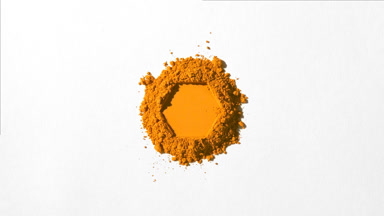 Orange Powder Stack with Hexagonal Impression on Grey Backdrop