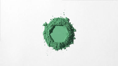 Green Powder with Hexagonal Shape on Light Grey Backdrop