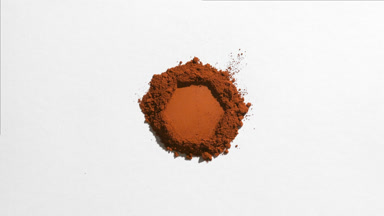 Hexagonal Brown Powder Pile on Light Grey Background