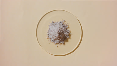 Overhead View of Beige Powder on Watch Glass