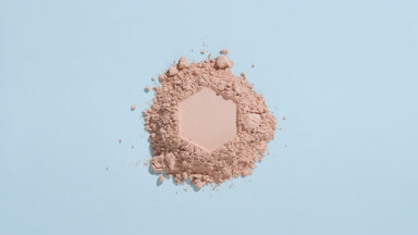 Beige Powder with Hexagonal Imprint on Blue Background
