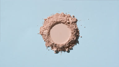 Mountain of Beige Powder with Round Imprint on Blue